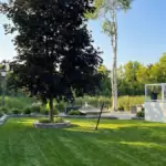 Sustainable design: Strategic retention and integration of established trees within the new landscaping.
